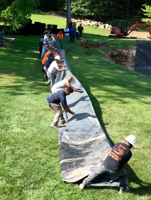 Pond builders often develop their own systems through years of hands-on work. Working beside another experienced builder can introduce a different method for setting stone, creating water movement, organizing a jobsite, operating equipment, or solving a filtration challenge. Those exchanges happened throughout the Vaynerchuk build.