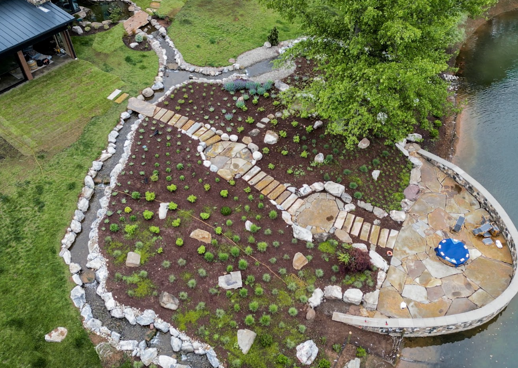 The stream begins with a pool near the koi pond's overflow, then widens and eventually splits into two streams. From there, the water follows a natural S-shaped path for approximately 75 feet, incorporating multiple spills, drops, and pools along the way.