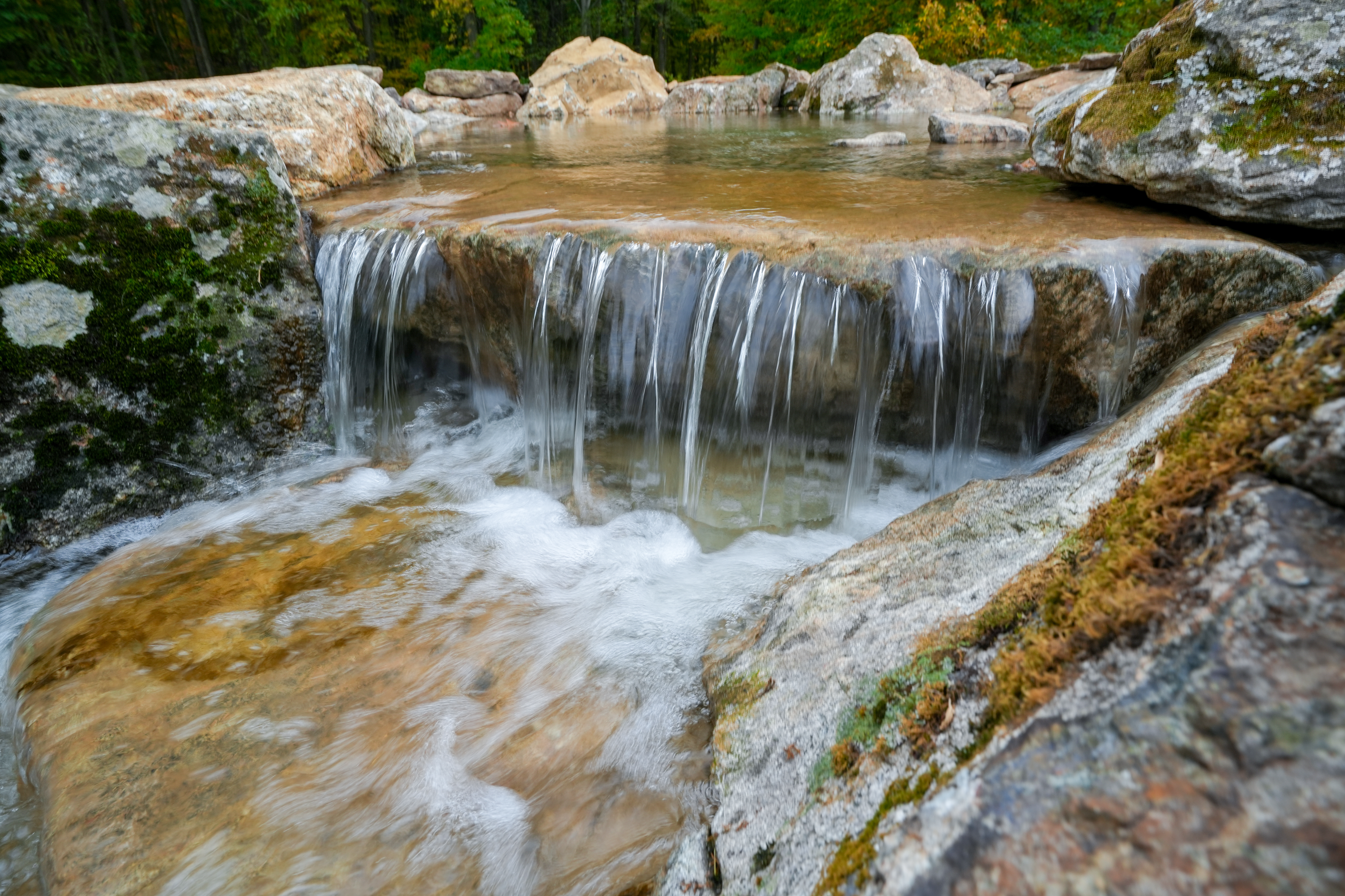 The skimming system, for example, couldn't be installed exactly the way we would approach a conventional koi pond with a predictable waterline. We had to position it lower in the pond and creatively disguise the mechanical components using faux-rock covers and surrounding stone.