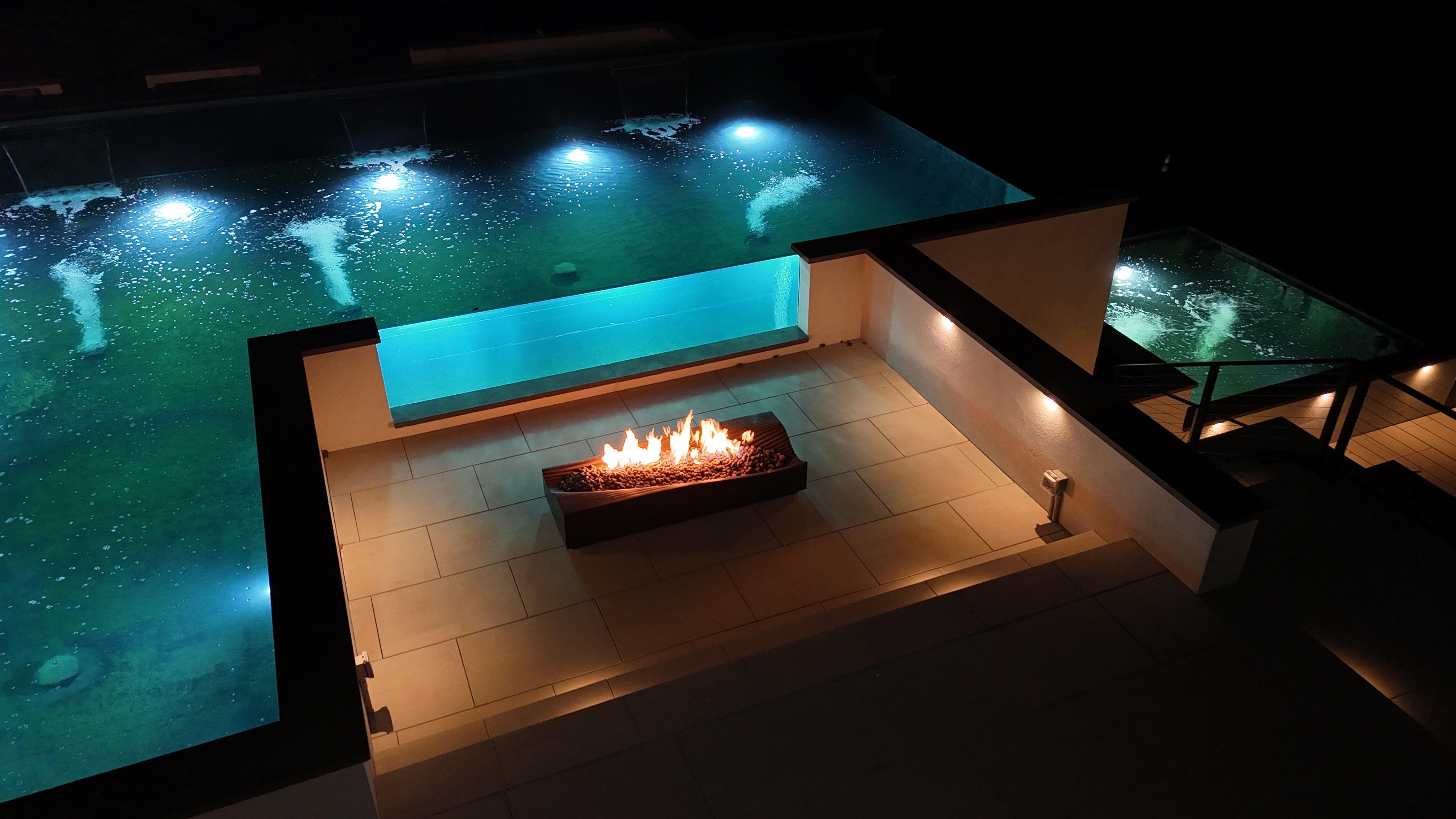 The result is a breathtaking, multi-level waterscape featuring a 35,000-gallon upper koi pond, a dramatic infinity edge, an 11-foot elevation change, a custom glass viewing window, and a cascading water wall. Behind the striking design lies an equally impressive system of structural engineering, insulated concrete construction, and dedicated filtration infrastructure. The result is a breathtaking, multi-level waterscape featuring a 35,000-gallon upper koi pond, a dramatic infinity edge, an 11-foot elevation change, a custom glass viewing window, and a cascading water wall. Behind the striking design lies an equally impressive system of structural engineering, insulated concrete construction, and dedicated filtration infrastructure.